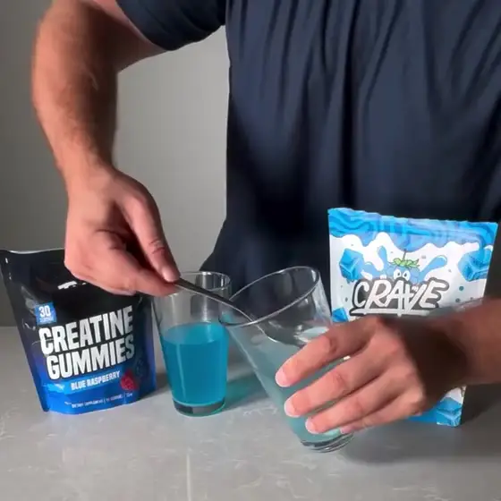 A spoon lifts a clump of undissolved creatine out of the Crave glass, then comes up clean from the other brand's glass